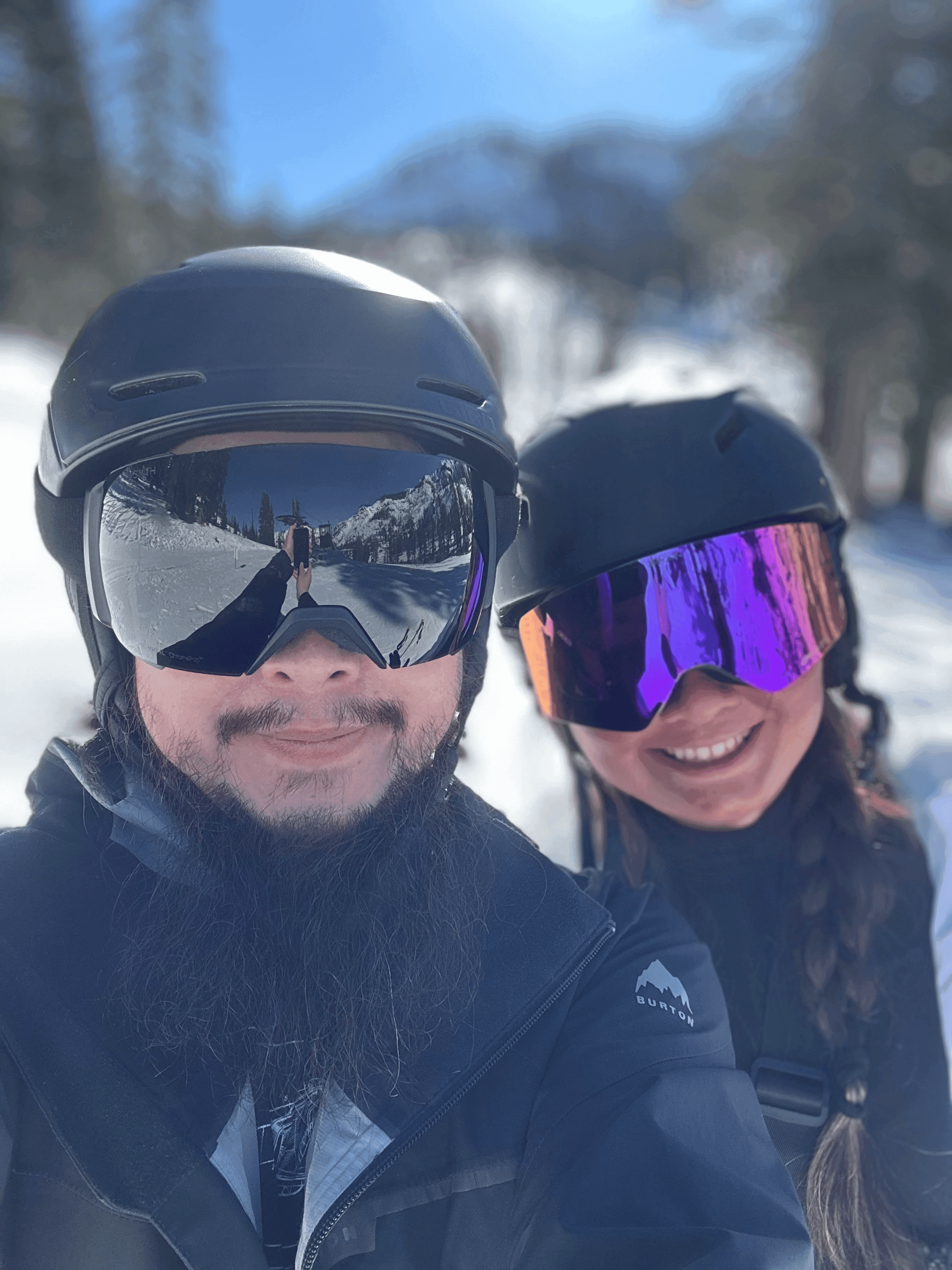 Co-founders Anthony Zheng and Dianna Zheng smiling in skiing gear on a sunny day on the slopes.